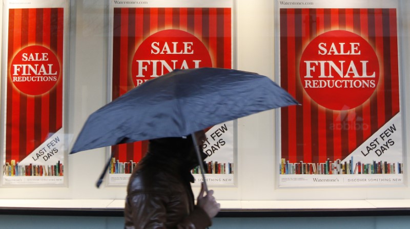 © Reuters. A woman walks past a Waterstone's book shop in London