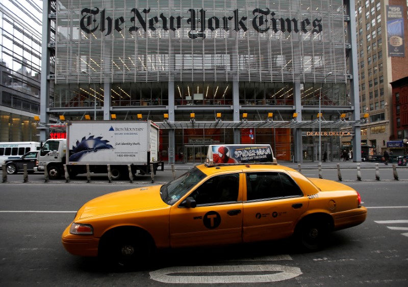 © Reuters. FILE PHOTO - A taxi passes by in front of The New York Times head office in New York