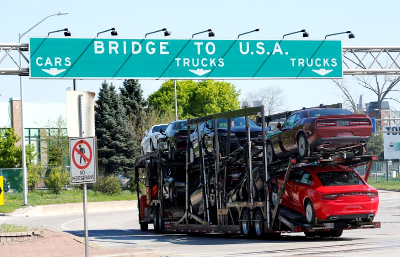 © Reuters. FILE PHOTO: A car hauler heading for Detroit, Michigan, drives on the lane to Ambassador Bridge in Windsor