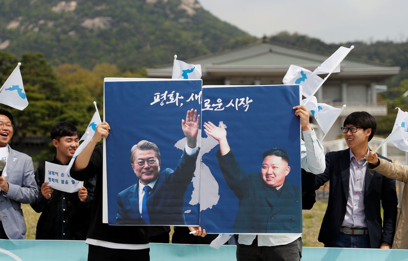 © Reuters. Estudantes seguram cartaz com líderes das Coreias em Seul