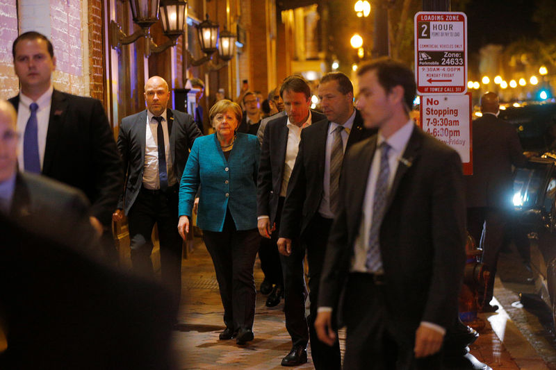 © Reuters. German Chancellor Angela Merkel walks back to her hotel after going out for a walk and dinner shortly after arriving in Washington