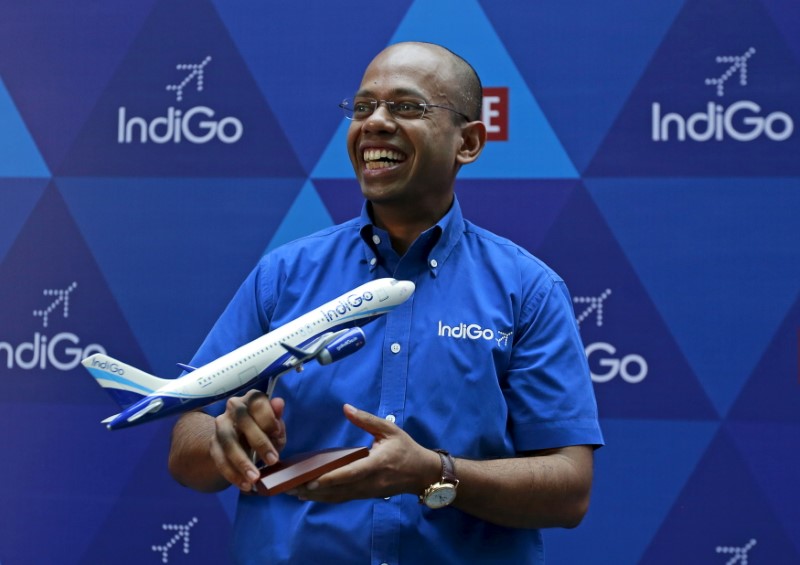 © Reuters. President of InterGlobe Aviation Limited Aditya Ghosh holds a memento during the company's listing ceremony at the National Stock Exchange (NSE) in Mumbai