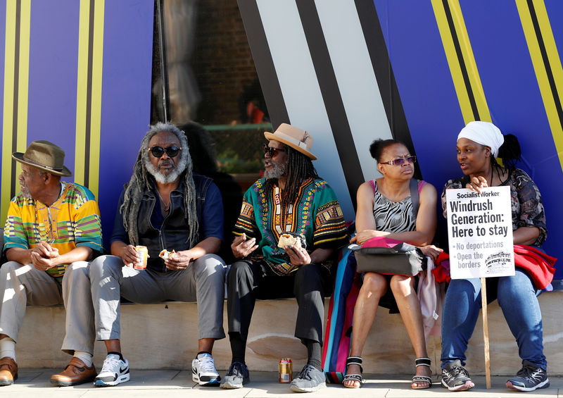 © Reuters. FILE PHOTO: People gather in Windrush Square to show solidarity with the Windrush generation in the Brixton district of London