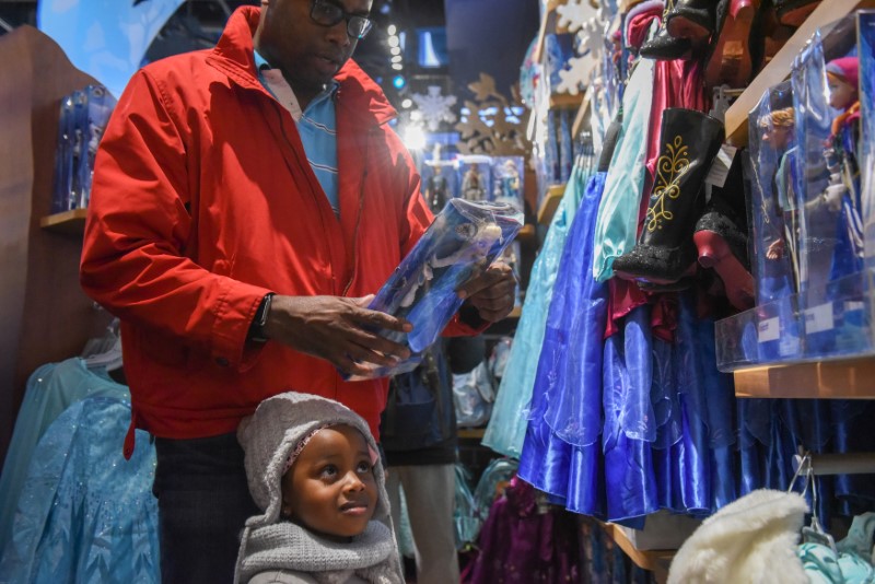 © Reuters. People shop for a princess doll at the Disney Store in Times Square in New York City