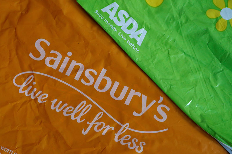 © Reuters. Shopping bags from Asda and Sainsbury's are seen in Manchester.
