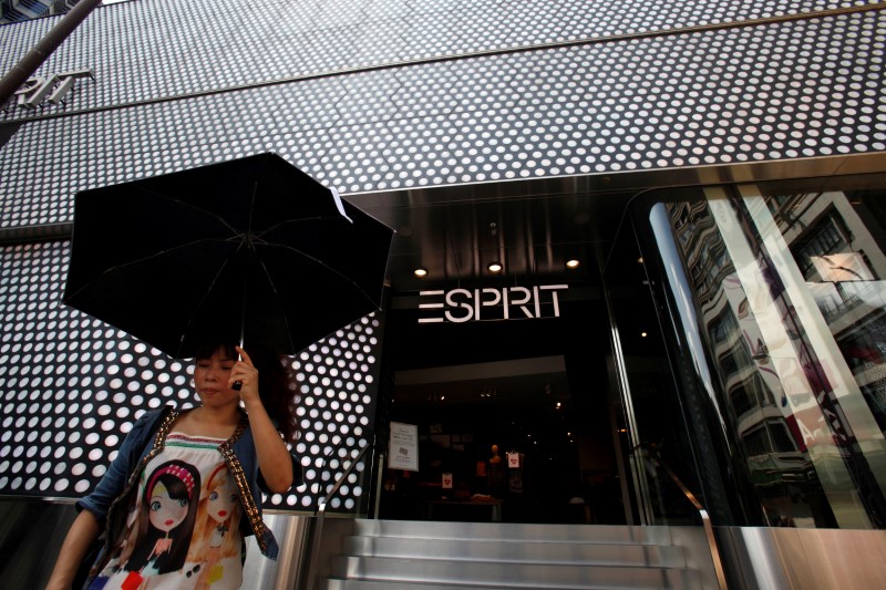 © Reuters. FILE PHOTO: Woman walks outside the biggest Esprit store at Hong Kong's Tsim Sha Tsui shopping district