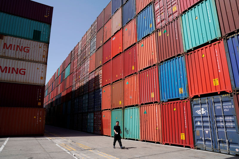 © Reuters. A man walks at a container area at the port in Shanghai