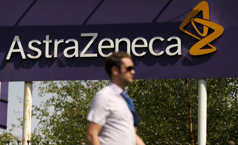 © Reuters. FILE PHOTO: A man walks past a sign at an AstraZeneca site in Macclesfield