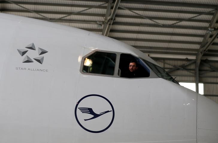 © Reuters. A technician looks out of the cockpit of a Lufthansa Airbus A330-300 aircraft in a maintenance hangar at Lufthansa Technik Malta at Malta International Airport outside Luqa