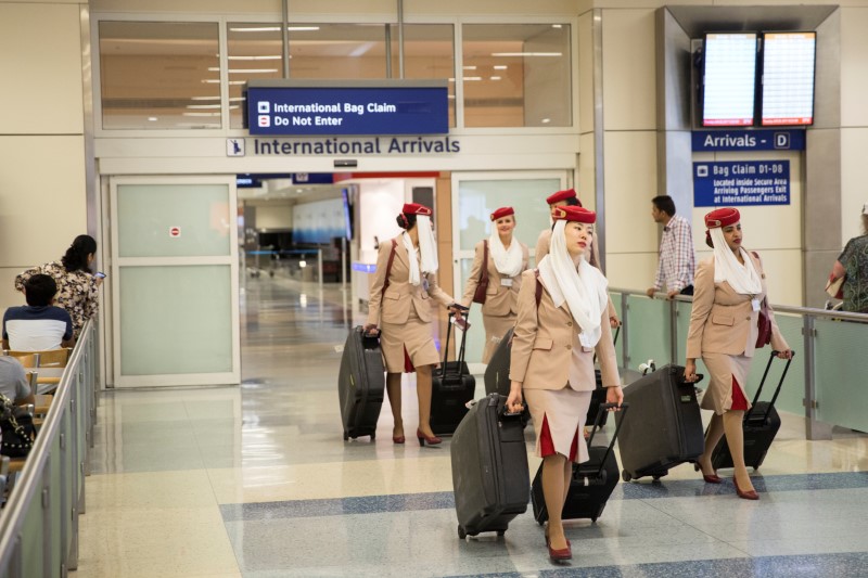 © Reuters. FILE PHOTO: Emirates Airlines flight attendants come through the International Arrivals gate from Dubai at Dallas/Fort Worth International Airport in Texas