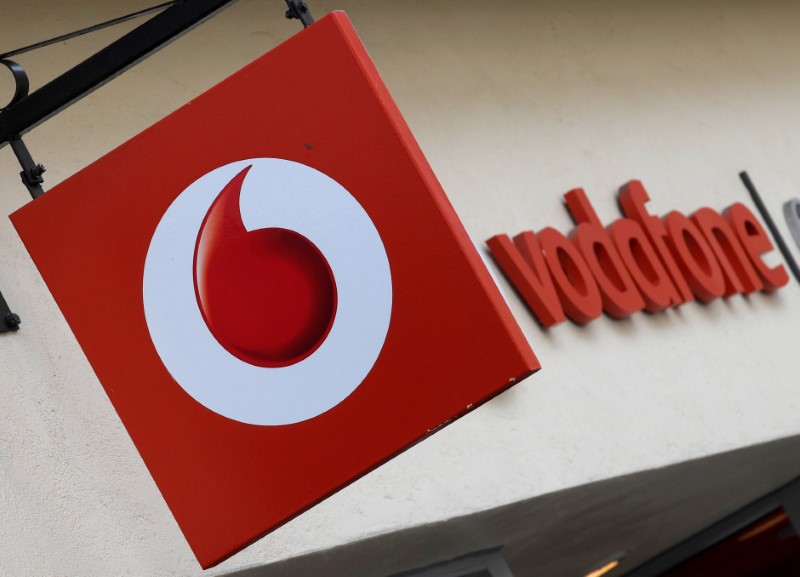 © Reuters. FILE PHOTO: Branding hangs outside a Vodafone shop in Oxford