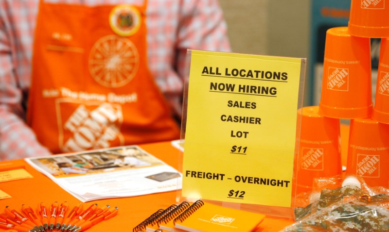 © Reuters. A sign seeking workers for Home Depot is seen at a job fair in Golden