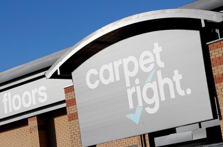 © Reuters. FILE PHOTO: A sign hangs above the door of a Carpetright store in Derby
