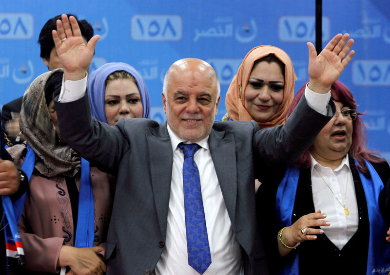 © Reuters. FILE PHOTO: Iraqi Prime Minister Haidar al-Abadi attends the election campaign, along with his supporters in Kirkuk
