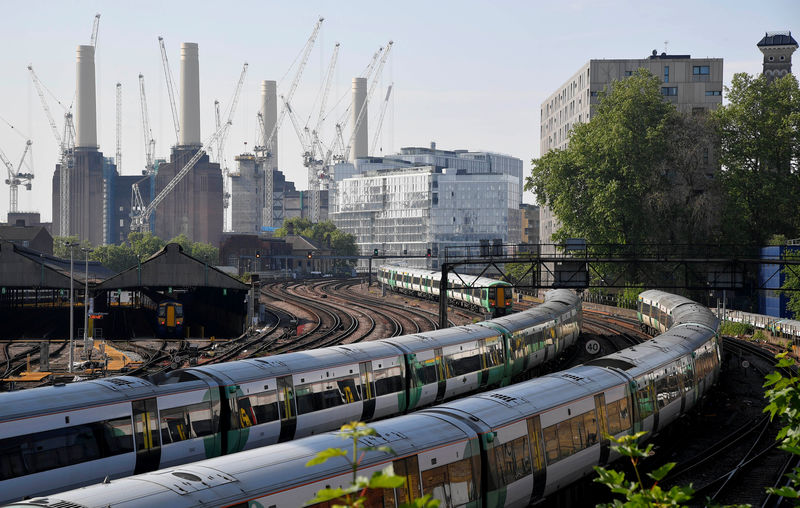 © Reuters. Trains pass near construction work taking place around Battersea Power Station in London, Britain
