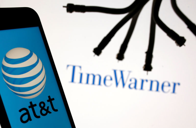 © Reuters. Smartphone with AT&T logo is seen in front of displayed Time Warner logo in this picture illustration
