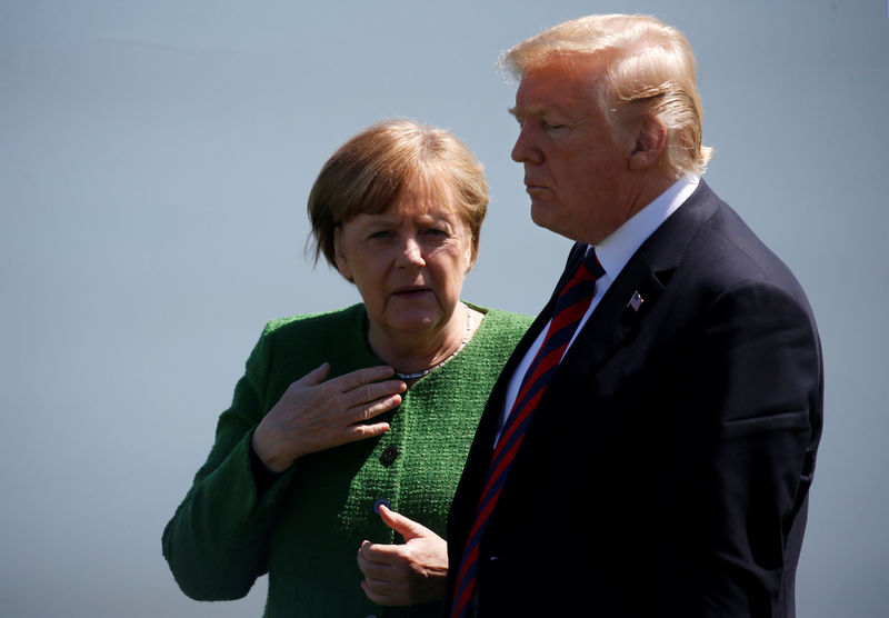 © Reuters. FILE PHOTO: Germany's Chancellor Merkel talks with U.S. President Trump at family photo at the G7 Summit in Charlevoix, Quebec