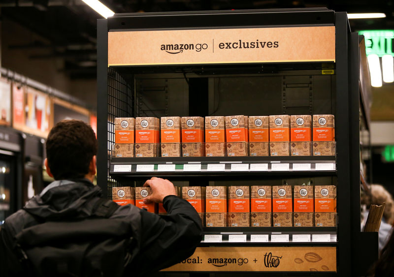 © Reuters. FILE PHOTO:    A customer selects an Amazon Go-branded Theo chocolate bar in the new Amazon Go store in Seattle