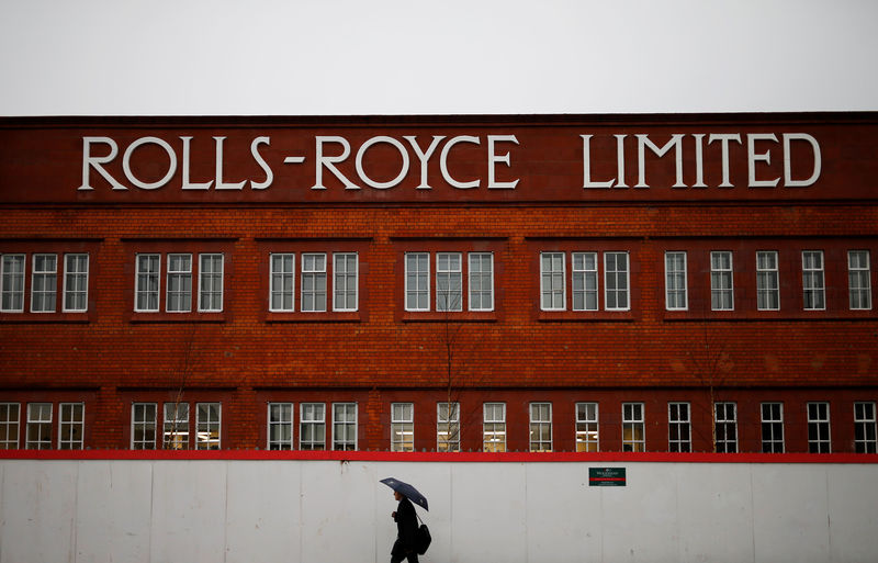 © Reuters. FILE PHOTO: A man walks past a former Rolls Royce site in Derby