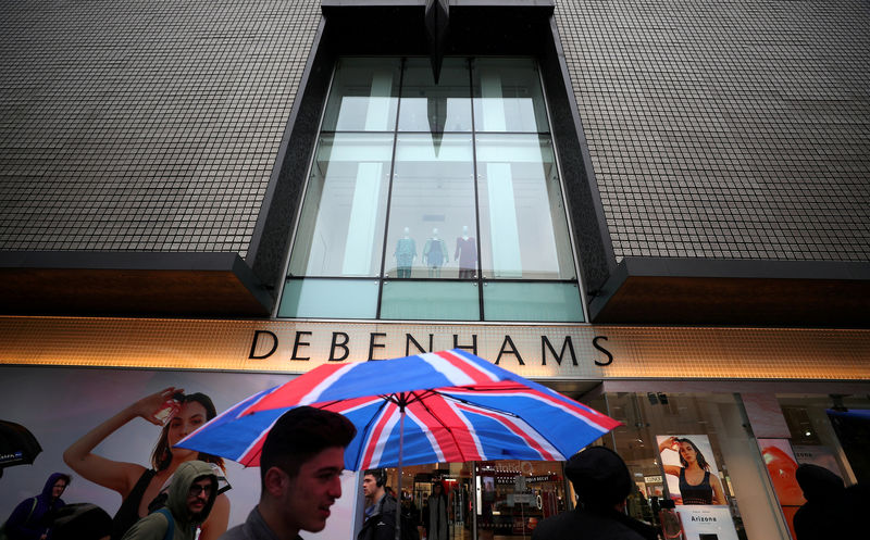 © Reuters. FILE PHOTO: Shoppers walk past Debenhams on Oxford Street in central London