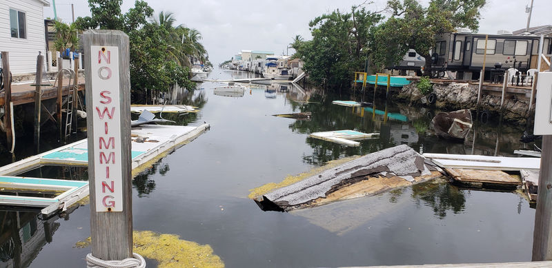 © Reuters. A debris-filled canal is seen, almost a year after Hurricane Irma, in Marathon