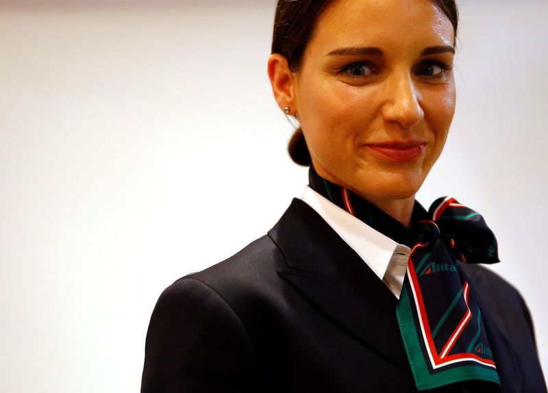 © Reuters. An Alitalia airline crew member poses with the new uniform during the official presentation of Alitalia's new Alberta Ferretti-designed uniforms in Milan