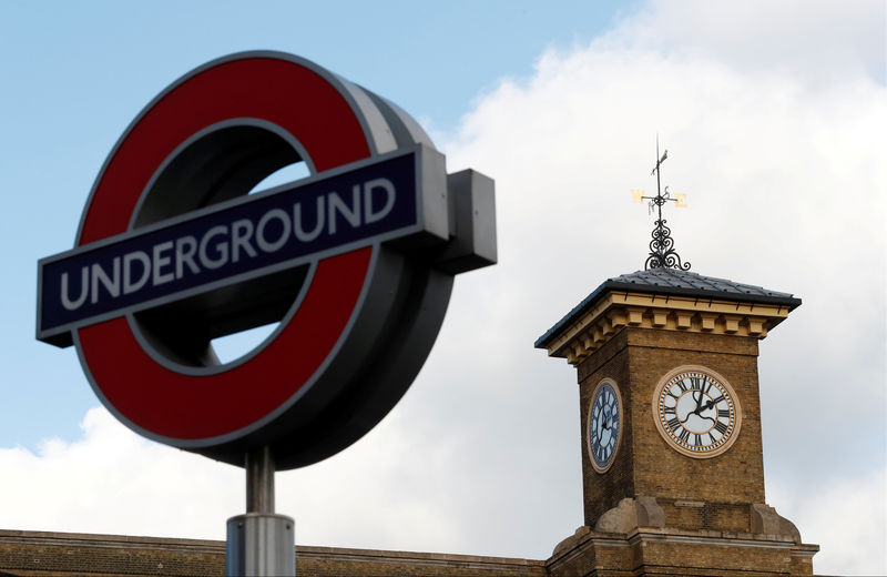 © Reuters. FILE PHOTO: An Underground tube sign is seen alongside a clock on London King's Cross railway station, London