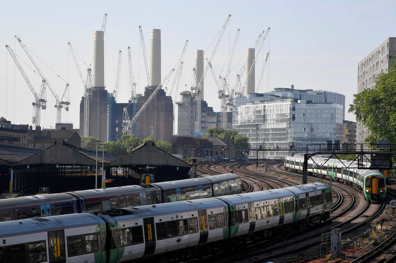 © Reuters. Trains pass near construction work taking place around Battersea Power Station in London, Britain