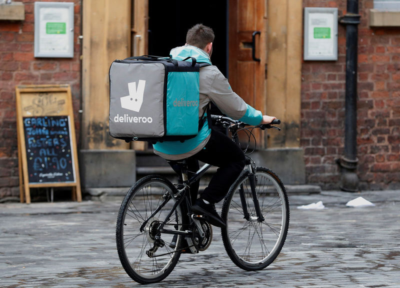 © Reuters. FILE PHOTO: A deliveroo worker cycles along a pedestrianised road in Liverpool