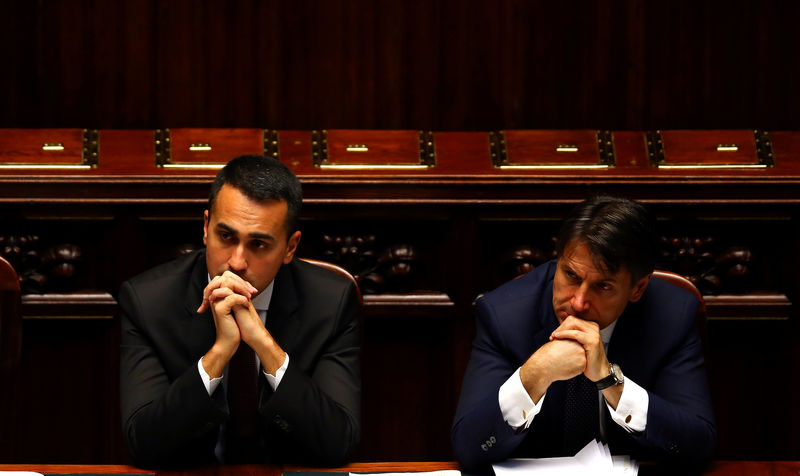 © Reuters. Italian Minister of Labor and Industry Luigi Di Maio listens next to Prime Minister Giuseppe Conte during his first session at the Lower House of the Parliament in Rome