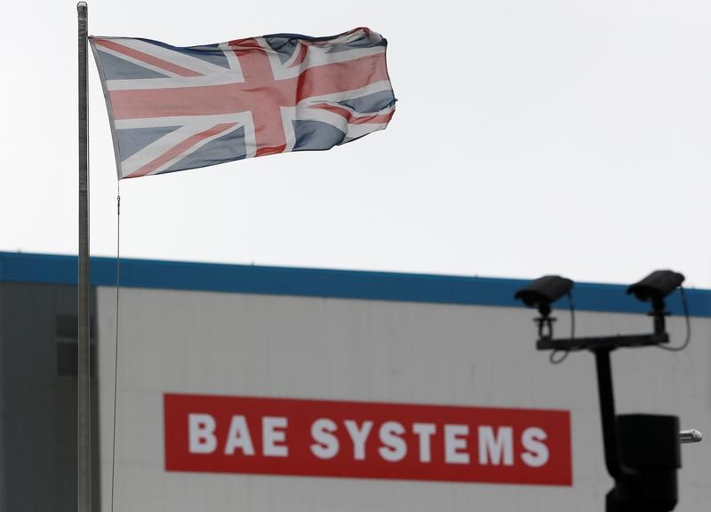 © Reuters. FILE PHOTO: A union flag flies over the entrance to the naval dockyards, where BAE Systems are also located, in Portsmouth