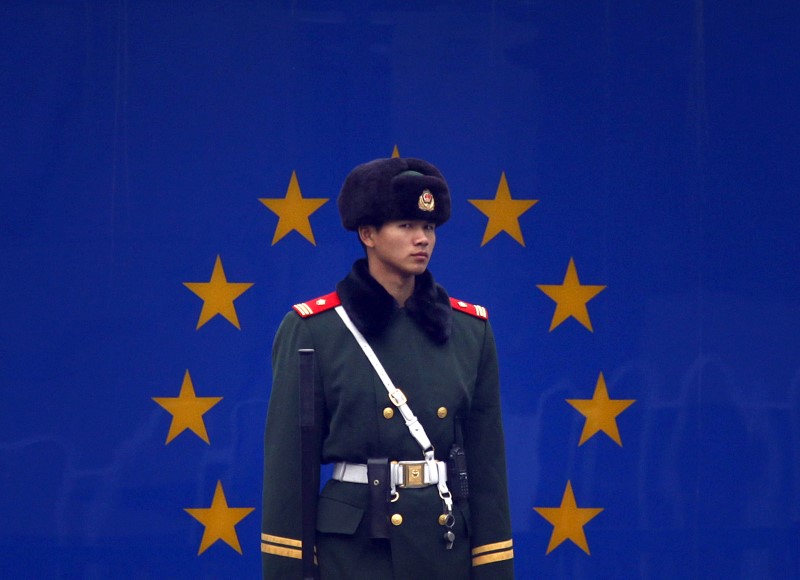 © Reuters. A paramilitary policeman stands guard at the entrance to the European Union embassy in central Beijing