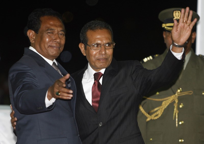 © Reuters. Newly appointed East Timor President Vasconcelos, waves his hand as he is greeted by Parliament Chief Araujo after the inauguration ceremony