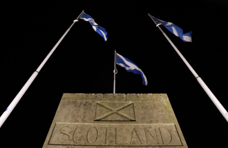 © Reuters. Saltire flags fly at the border between England and Scotland near Berwick on Tweed , Scotland