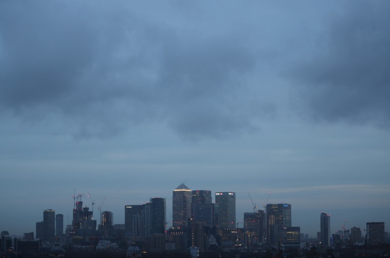 © Reuters. FILE PHOTO: The Canary Wharf financial district is seen during early morning mist from Greenwich Park in London