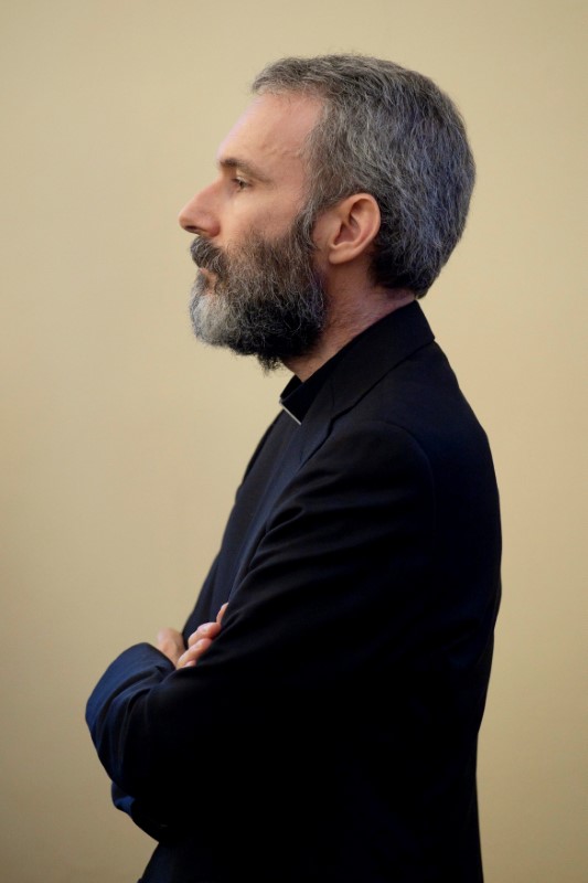 © Reuters. Father Carlo Alberto Capella, a Catholic priest sentenced to five years in jail for possessing child pornography, listens to the sentence during a trial at the Vatican