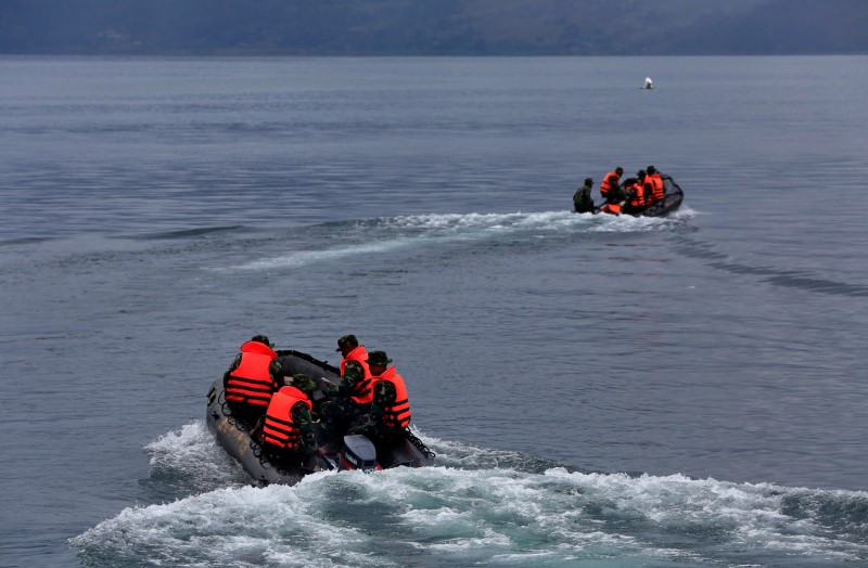 © Reuters. إندونيسيا تحدد موقعا تشتبه أنه لعبارة غارقة في قاع بحيرة