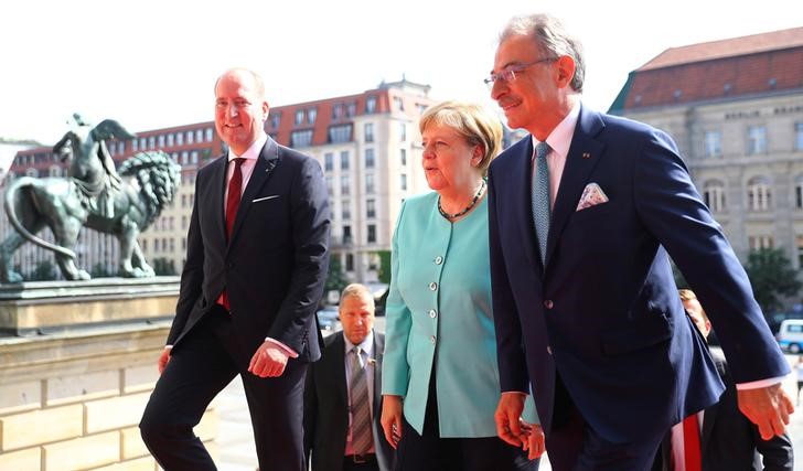 © Reuters. BDI president Kempf and Director General Lang welcome German Chancellor Merkel to the German Industry Day, hosted by the BDI industry association, in Berlin