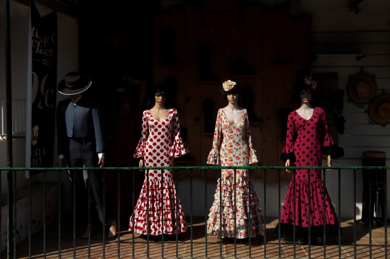 © Reuters. Flamenco outfits are displayed at a shop next to the shrine of El Rocio in Almonte, southern Spain