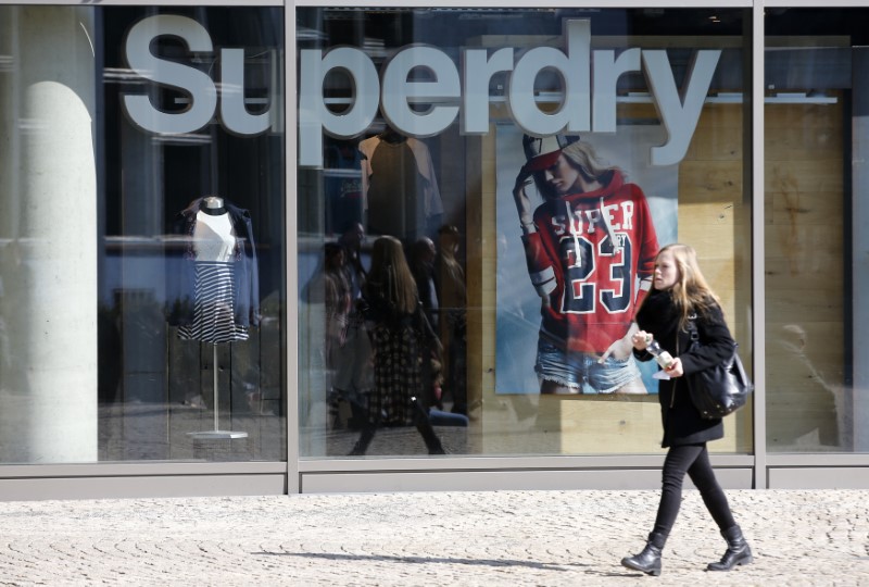 © Reuters. A woman walks past a Superdry fashion store in Berlin