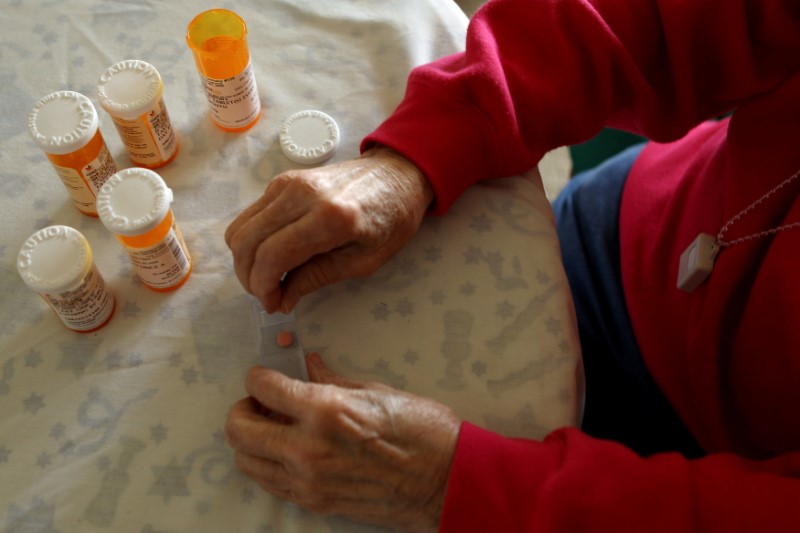 © Reuters. FILE PHOTO:   A senior citizen sorts her daily medical prescriptions at her independent living apartment in Maryland