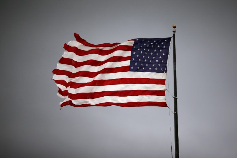 © Reuters. Storm clouds loom over an American flag in Convent