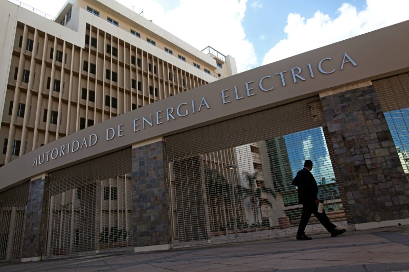 © Reuters. A man walks past the headquarters of the Puerto Rico Electric Power Authority (PREPA) in San Juan