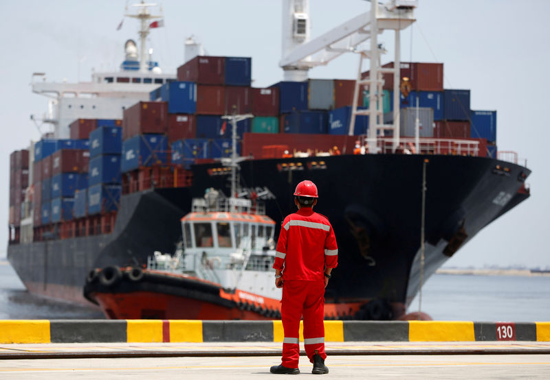 © Reuters. FILE PHOTO: A port worker watches as a ship leaves the New Priok Container Terminal 1 in North Jakarta