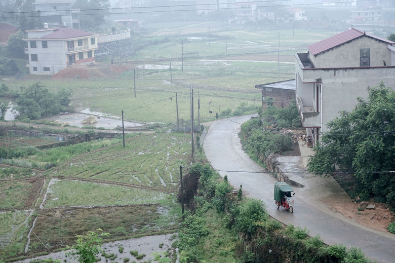 © Reuters. Man rides past houses at Furong village