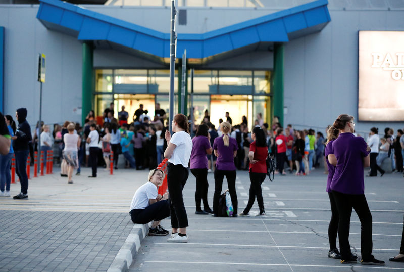 © Reuters. People stand outside a mall that was evacuated in the World Cup city of Samara