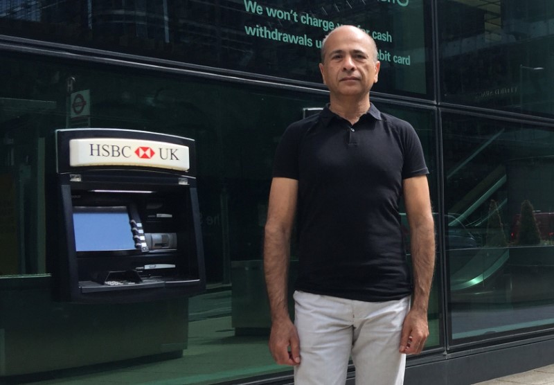 © Reuters. Abdul Aziz, an HSBC customer who says the bank ruined his business, standing outside the bankÕs headquarters in Canary Wharf, London