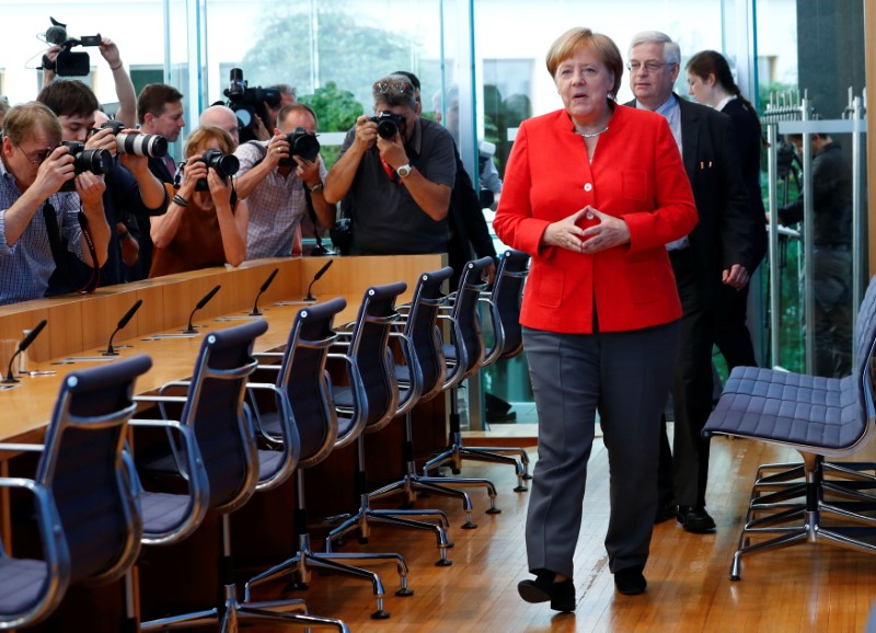 © Reuters. German Chancellor Angela Merkel arrives for the annual summer news conference in Berlin