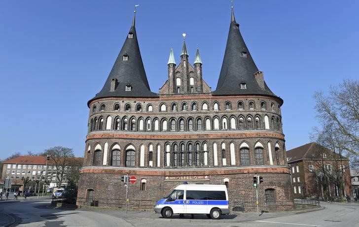 © Reuters. A police car stands in front of famous landmark Holstentor in downtown Luebeck