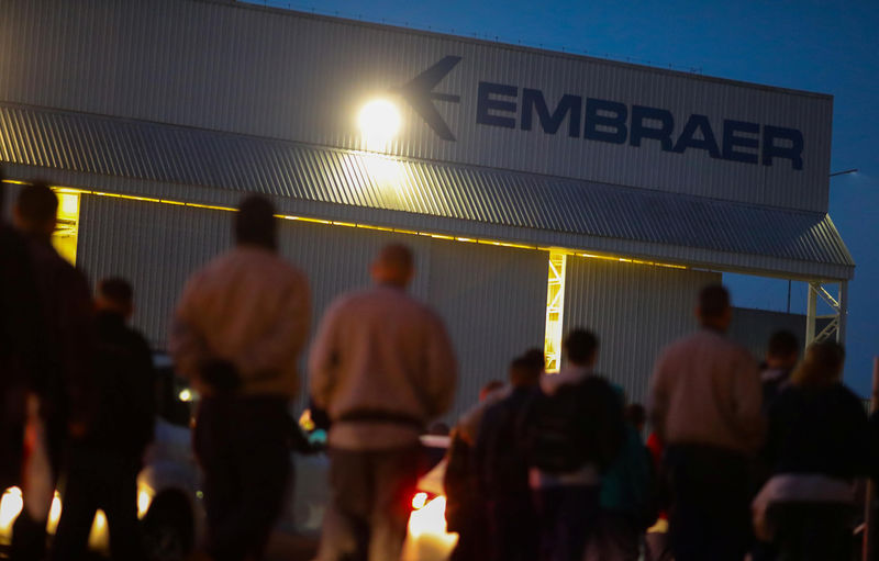 © Reuters. Employees of the Brazilian aviation company Embraer are seen in front of the factory in Sao Jose dos Campos